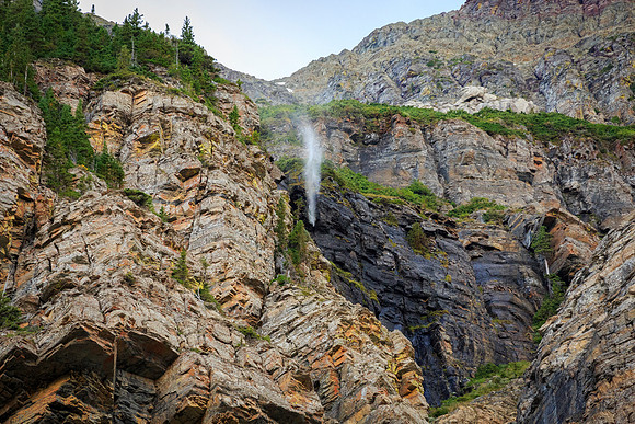 Water falls until it hits open air then it's caught by a strong updraft and blown back up.